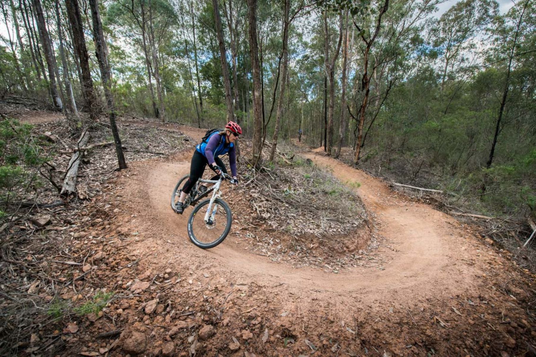 A woman on a mountain bike riding around a loop