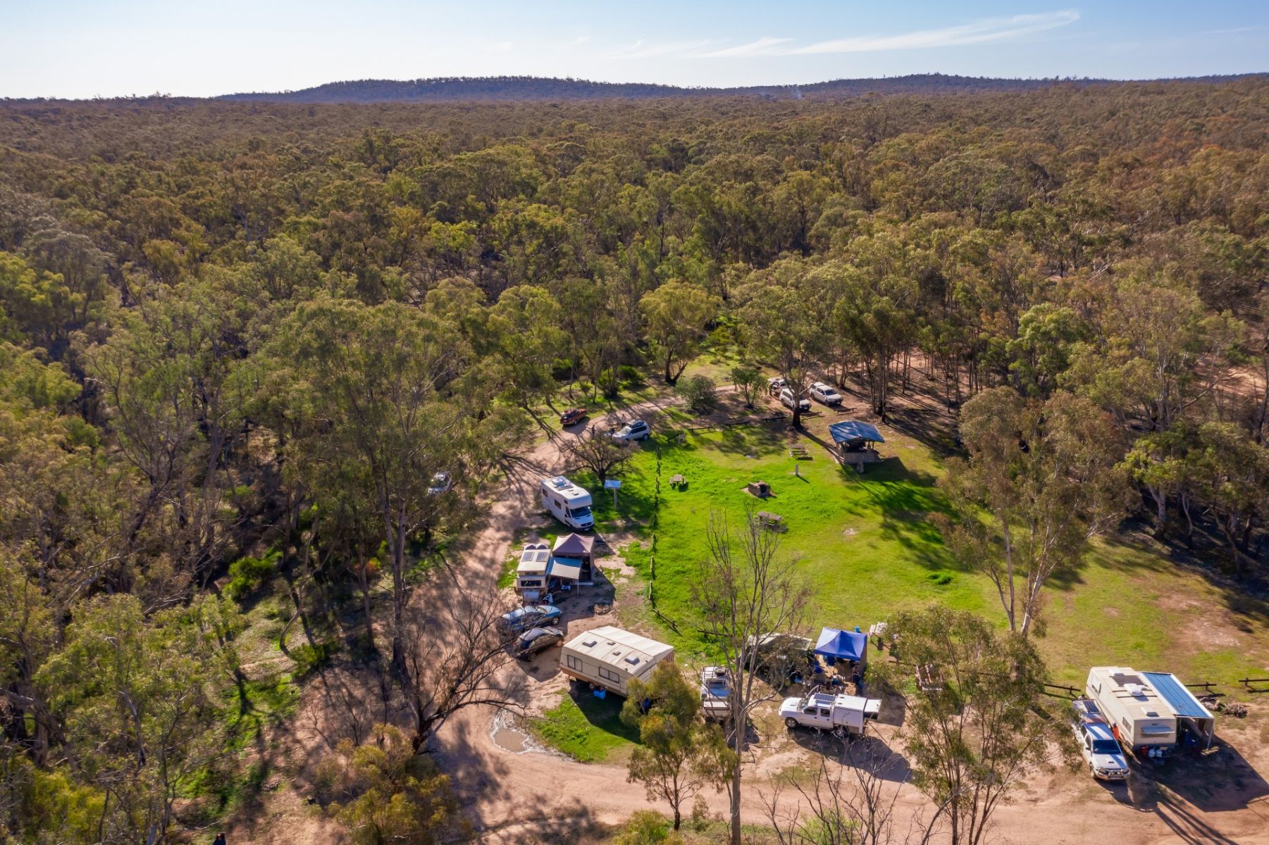 Aerial view of the campground with cars and campervans