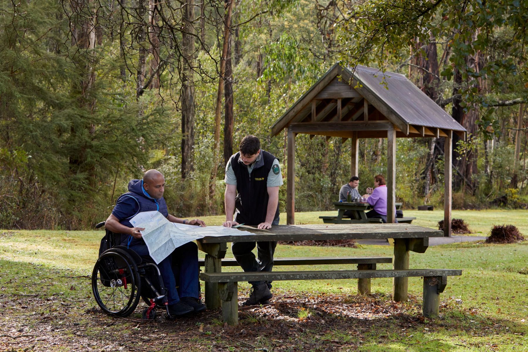 DELWP staff member with civilian looking at map