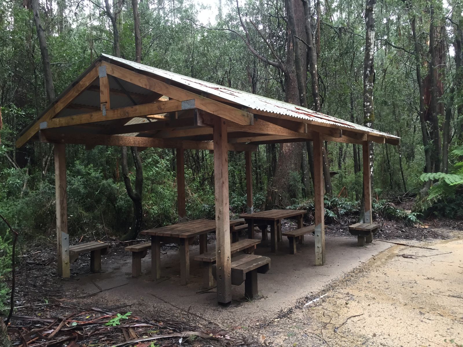 A picnic shelter covers two picnic tables