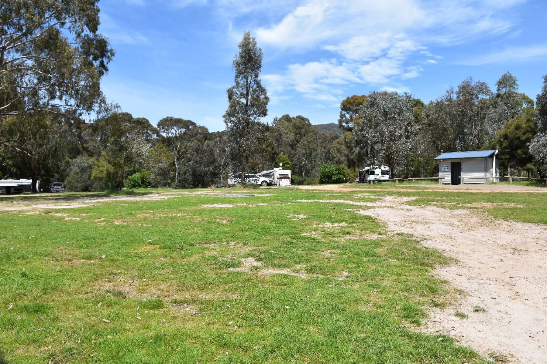 Two caravans set up at camp sites and an amenity block located nearby