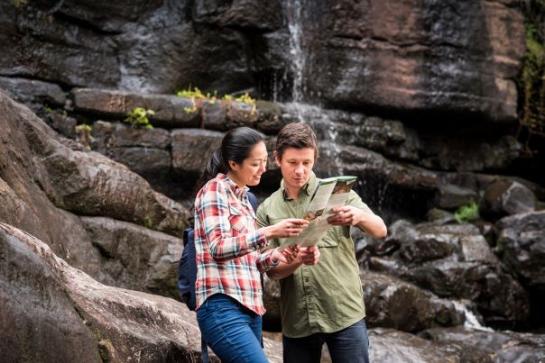 A woman and a man read a map