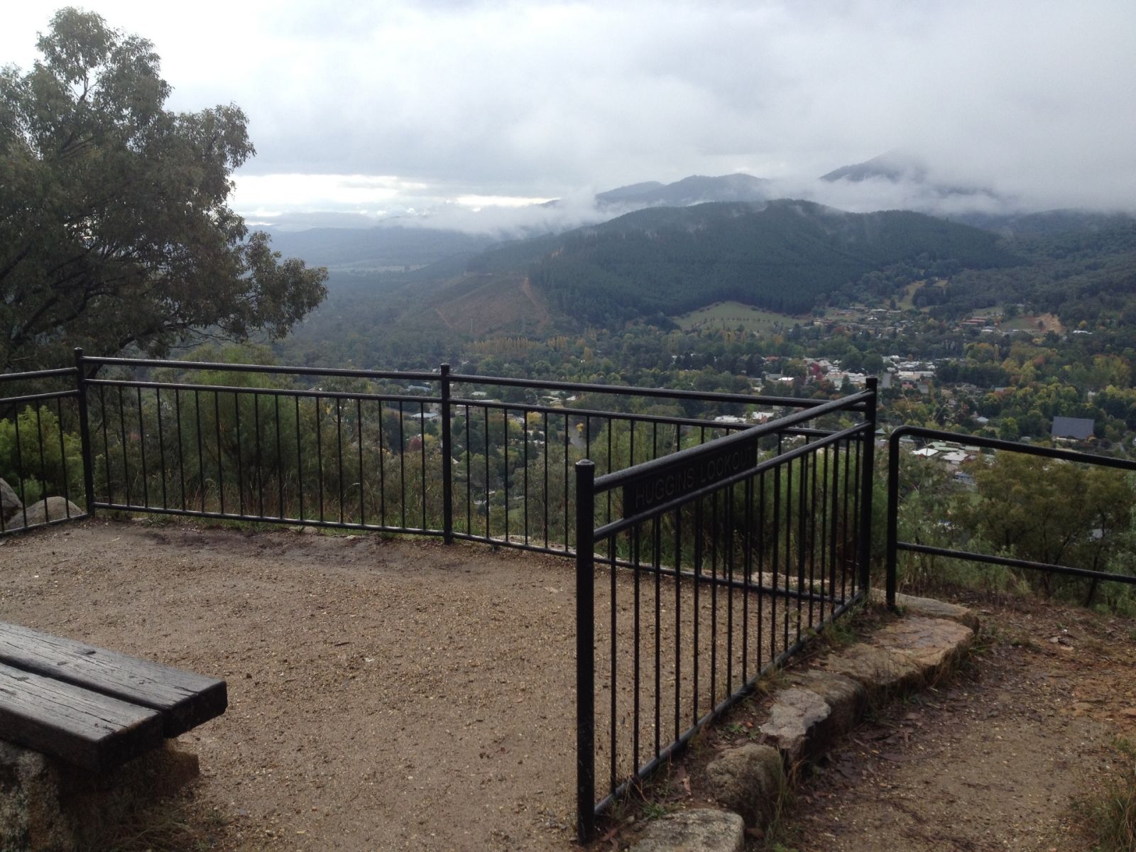 A lookout on a mountain summit with views of the town below