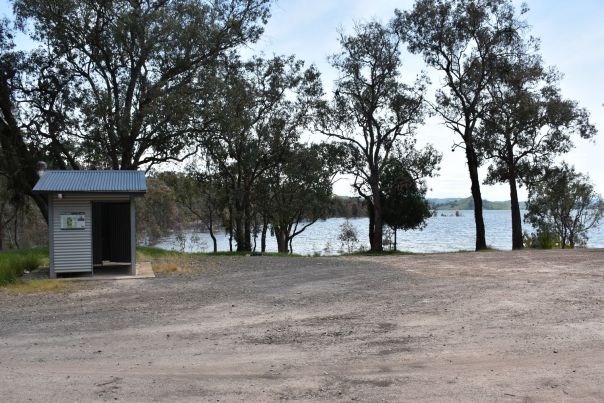 Flat open gravel area in front of the lake you can bring your car right up