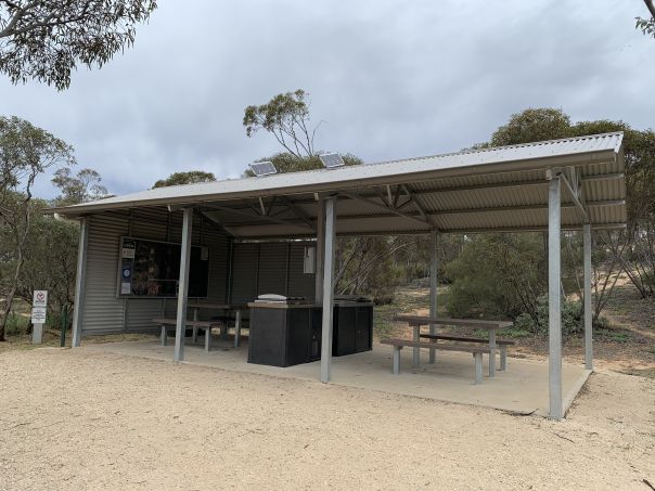A metal picnic shelter at a campground