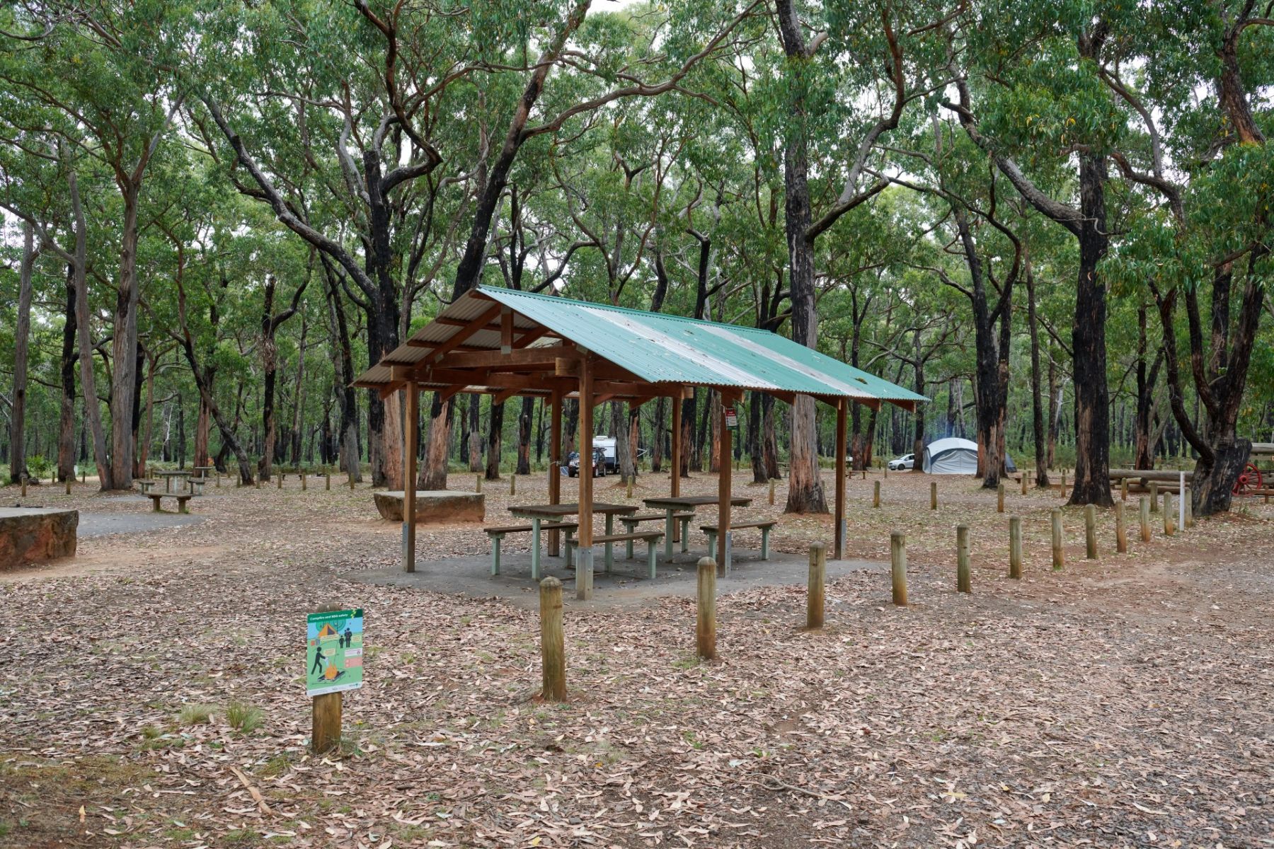 A picnic shelter with two picnic tables