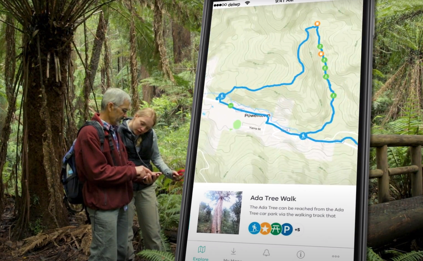 Two people looking at the More to Explore app on a phone 