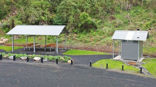 Picnic shelter and toilet connected by wide gravel paths