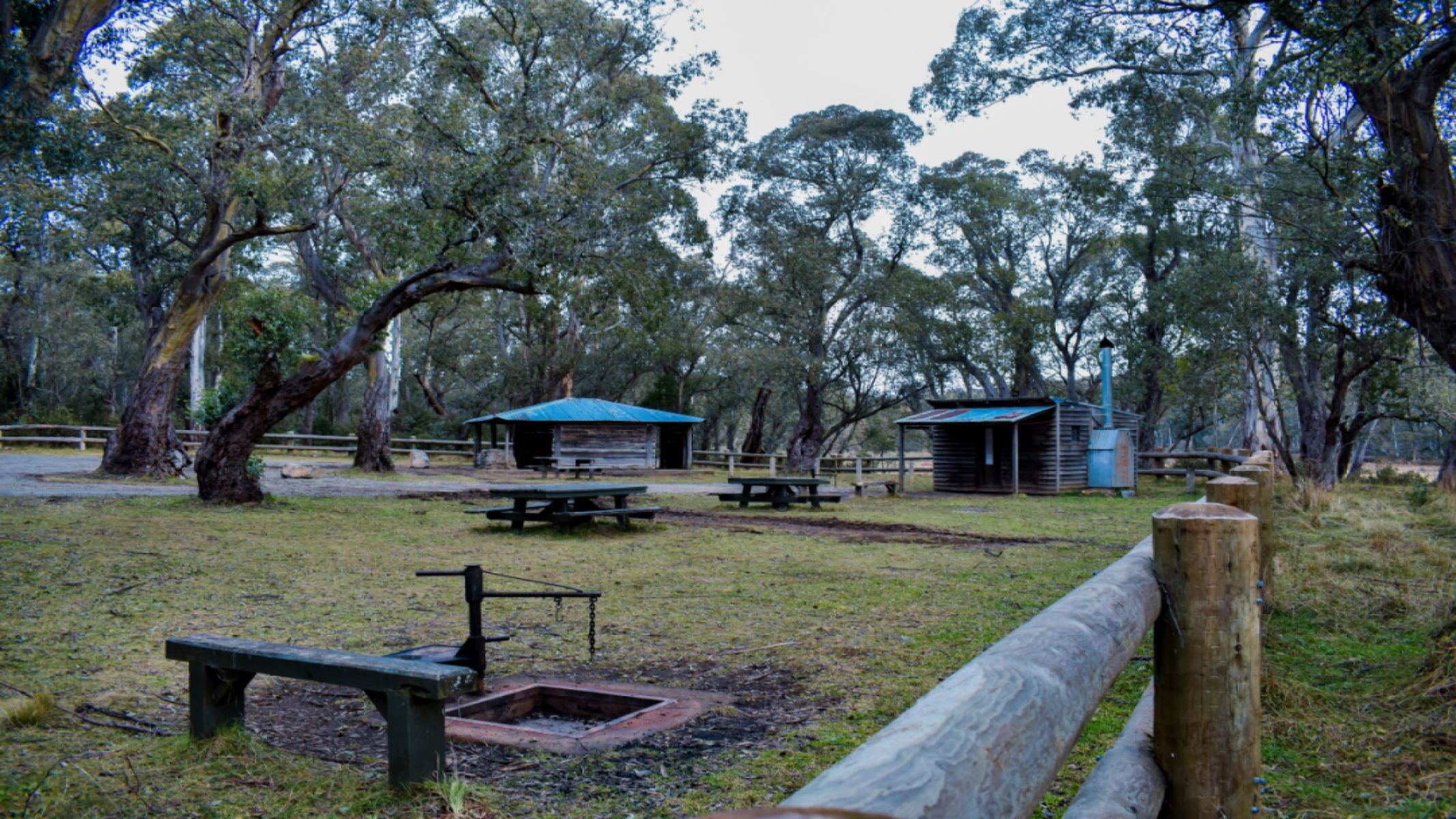 An historic forestry worker hut structure in a grassy area