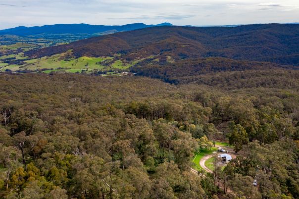 A view from above of a clearing where a campground is located among bushland.