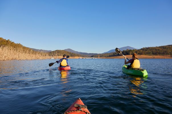 Three people canoeing on a lake