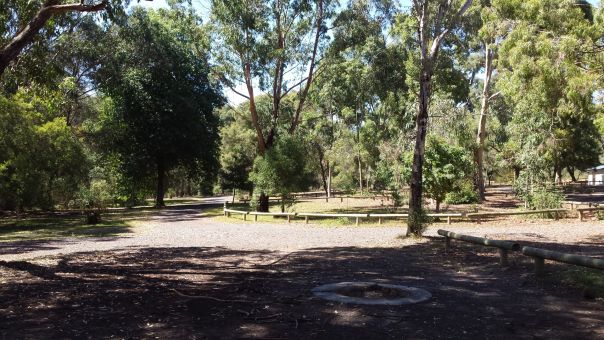 A large gravel and dirt area of a campground