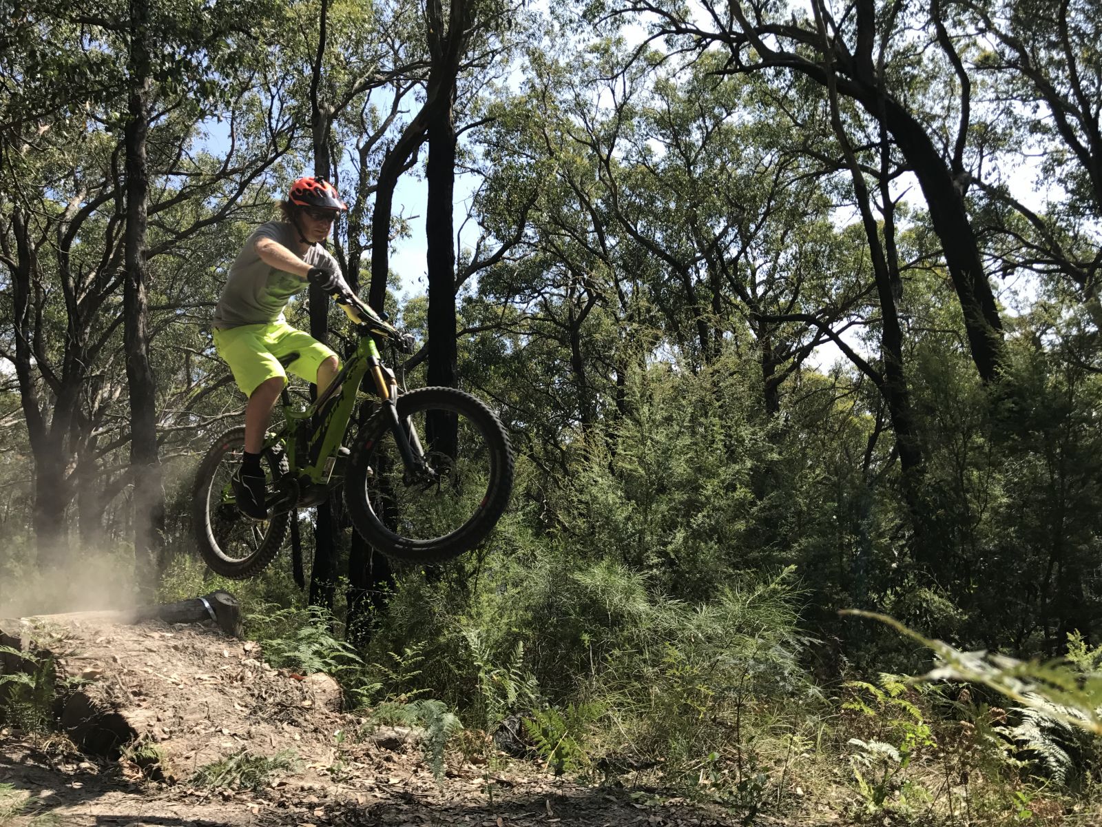 A man rides his mountain bike along a dirt track