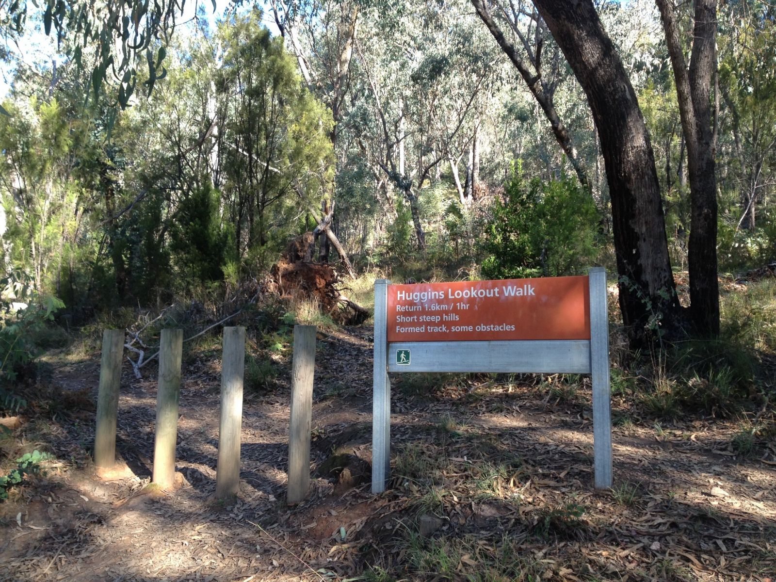 A sign reads Huggins Lookout Walk at the start of a walking trail