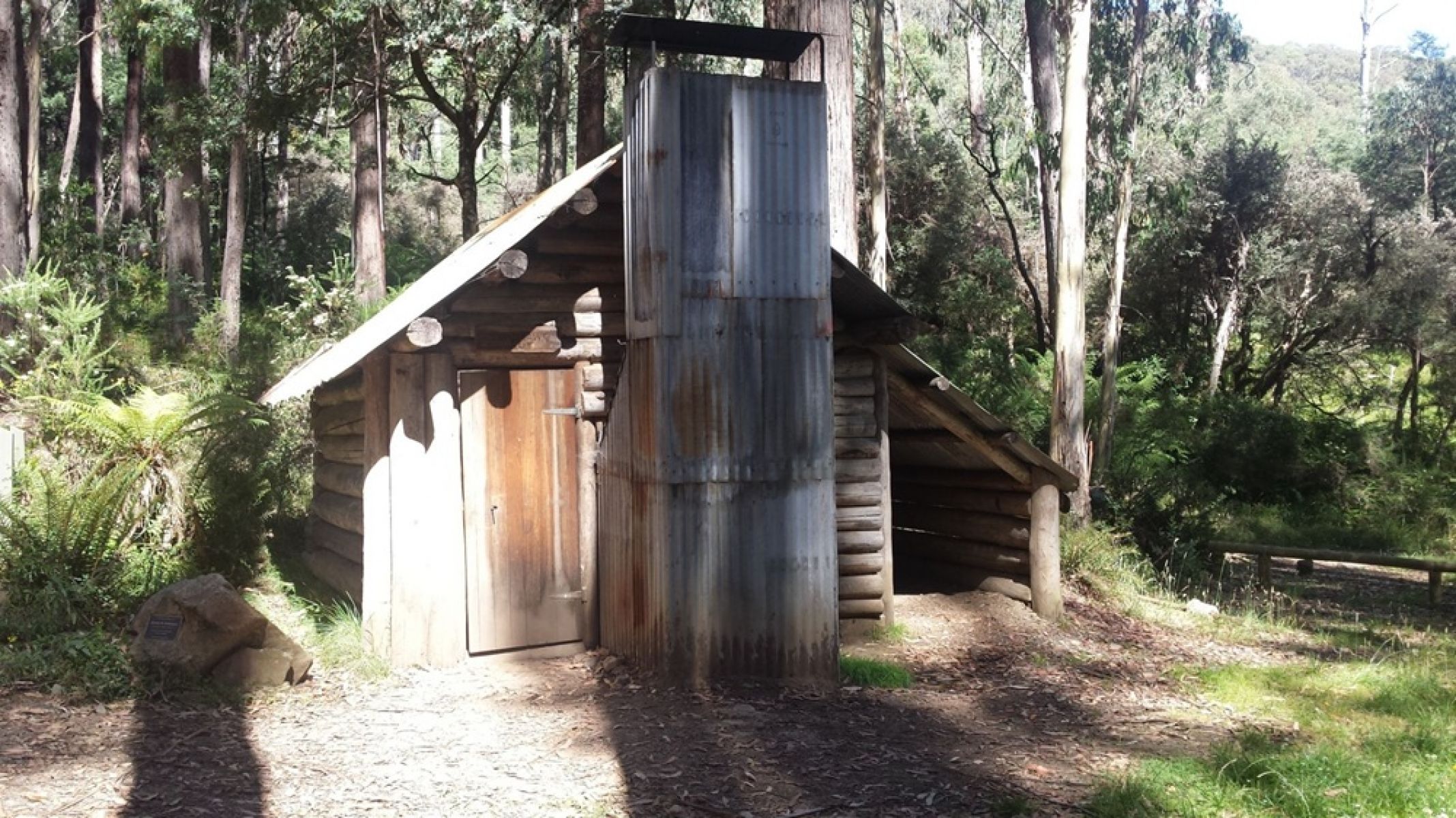 An old historic wooden and steel hut in the forest. 