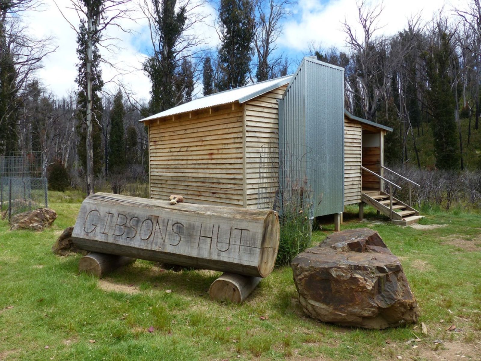 A woden hut in a grassy clearing