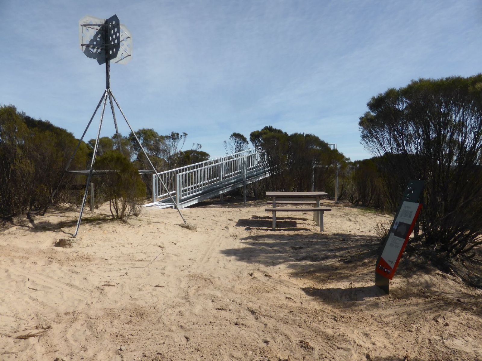 Entrance to Hermans hill lookout point. A sandy incline up to a bridge.