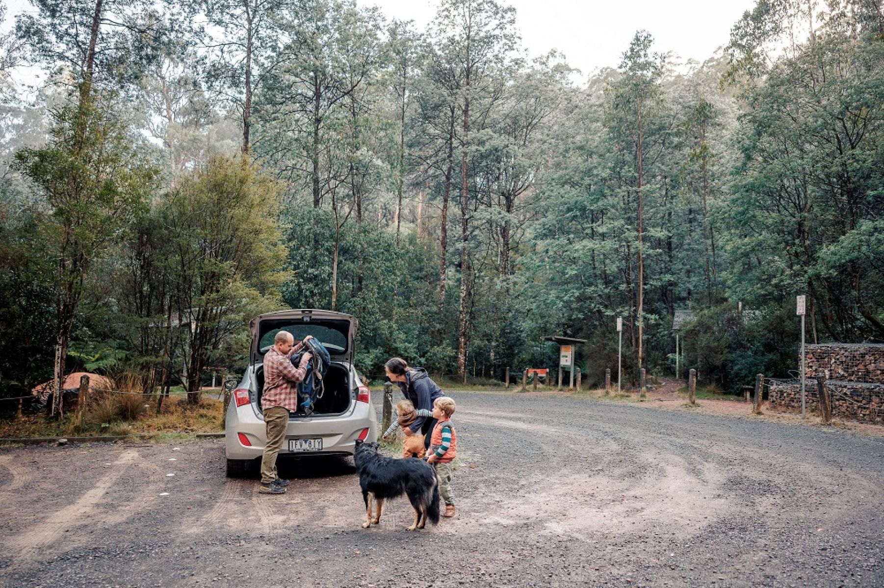 Car and people in gravel carpark