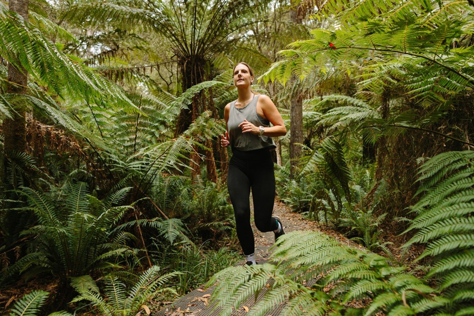 A person jogging along a forest trail