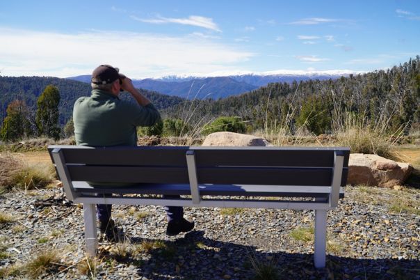 Person on a seat with mountains in backdrop