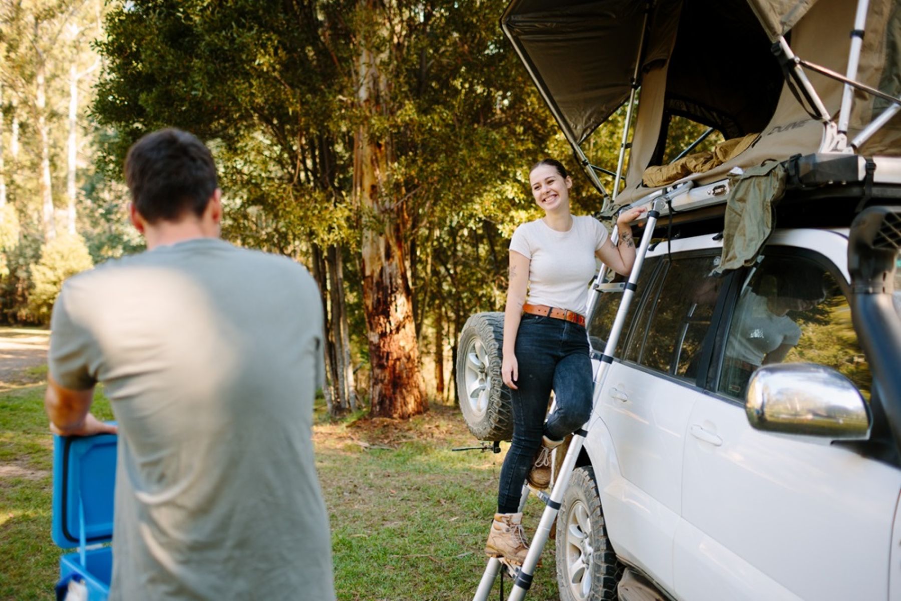 Two people beside a 4WD vehicle
